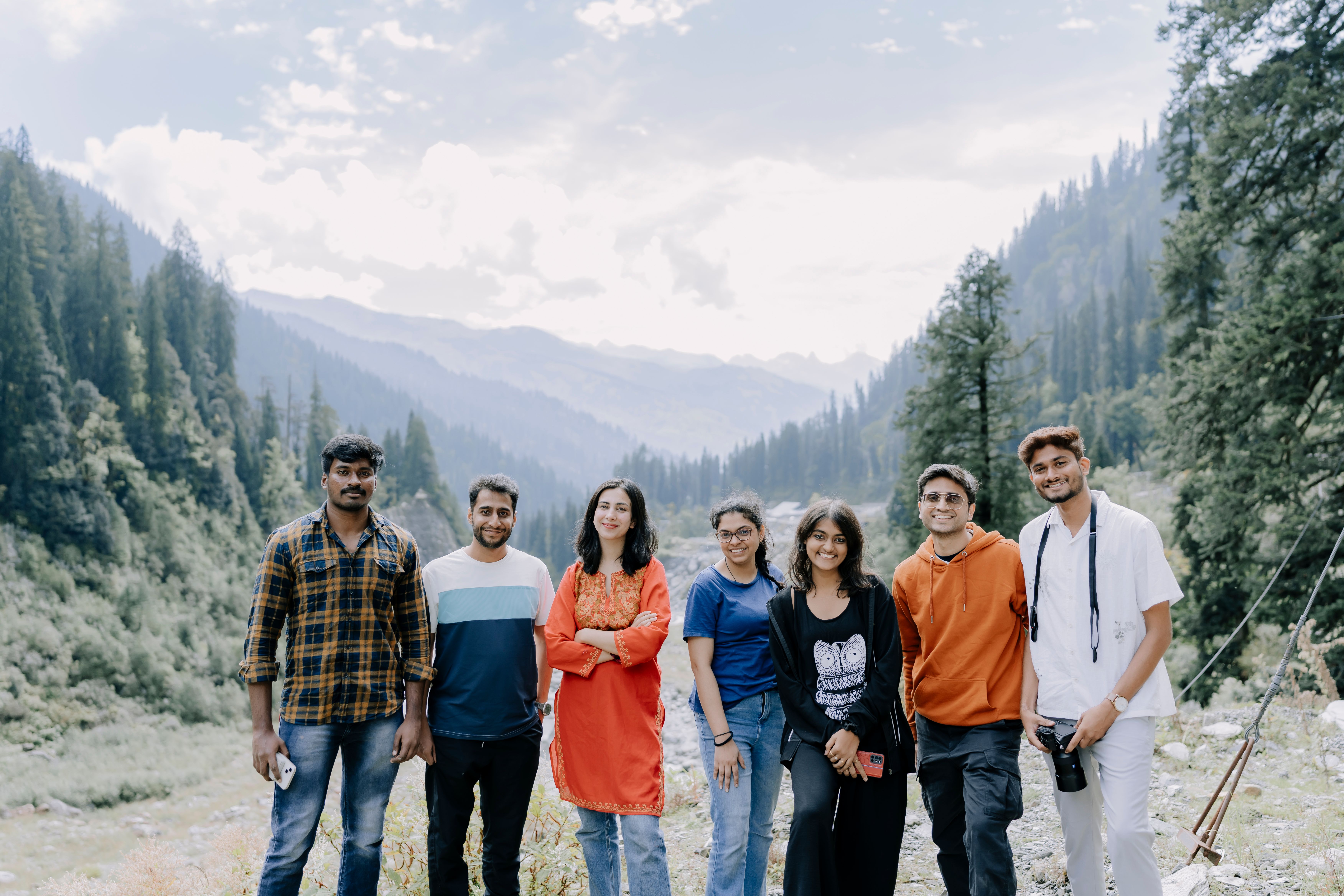 A group of smiling friends on a mountain trail